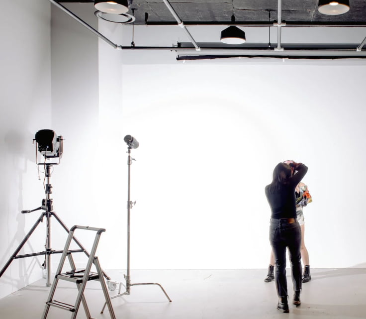 A female photographer and a model are doing a photoshoot session in the photo studio Bali.